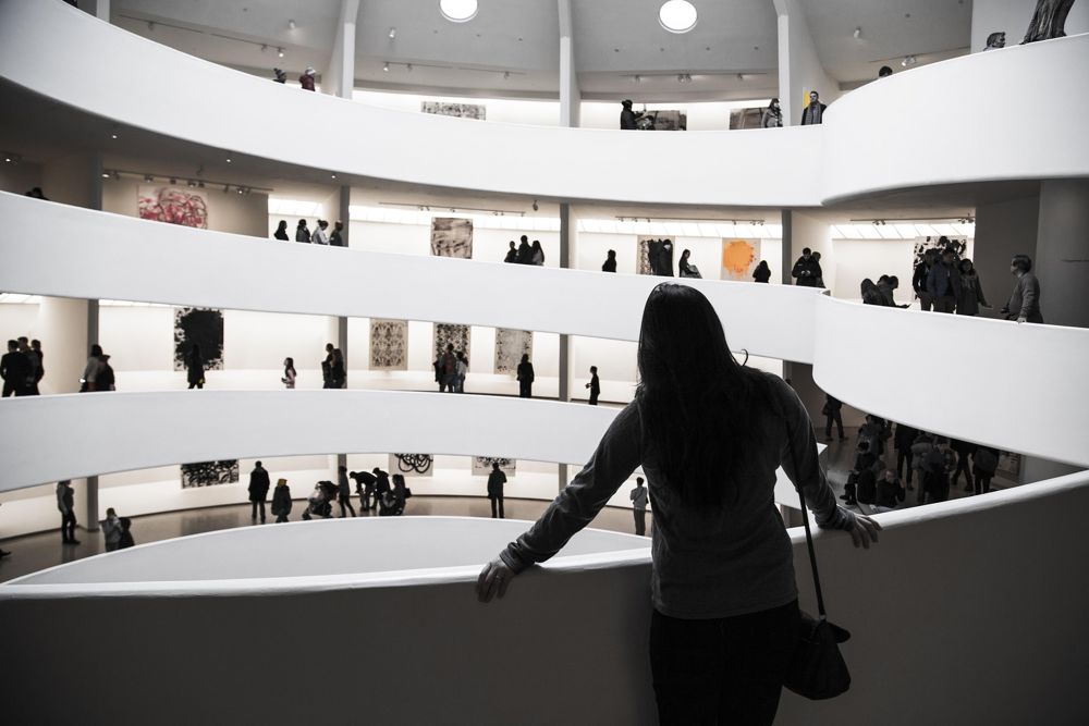 Visitor looking across a gallery atrium